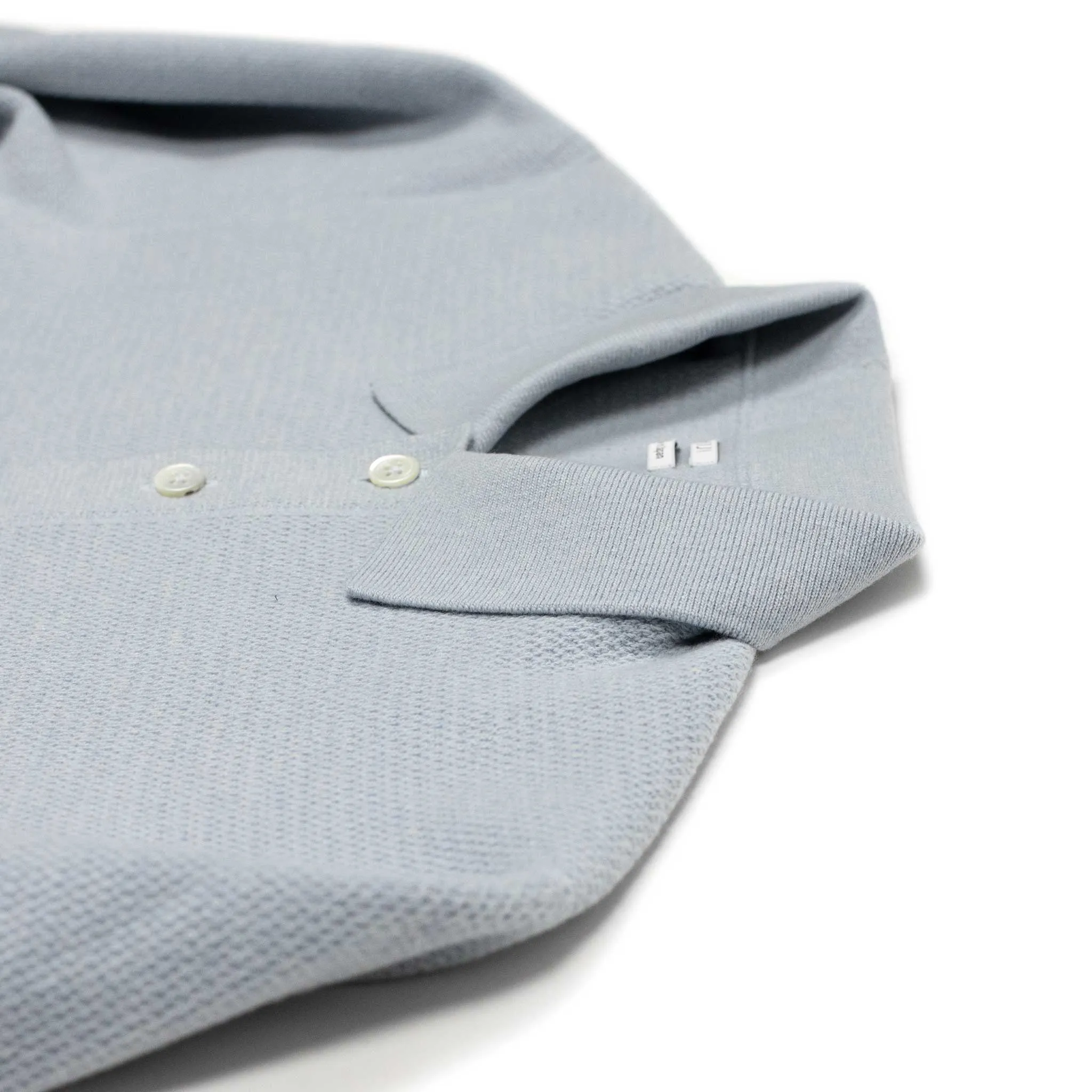 Molded knit long sleeve polo in micro-honeycomb light blue melange wool